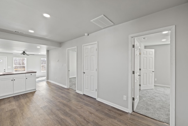 interior space with baseboards, visible vents, and wood finished floors