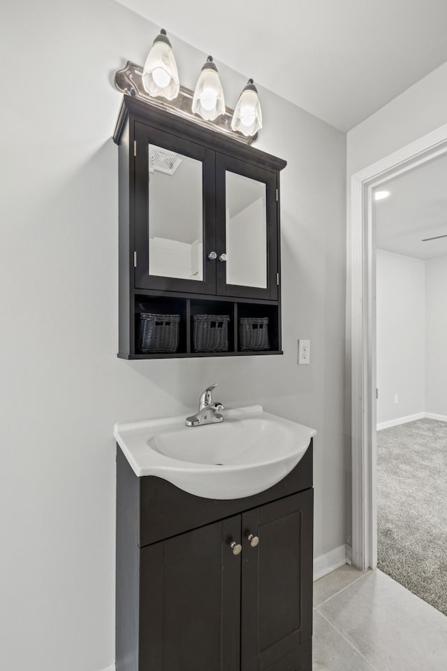 bathroom with tile patterned floors, vanity, and baseboards