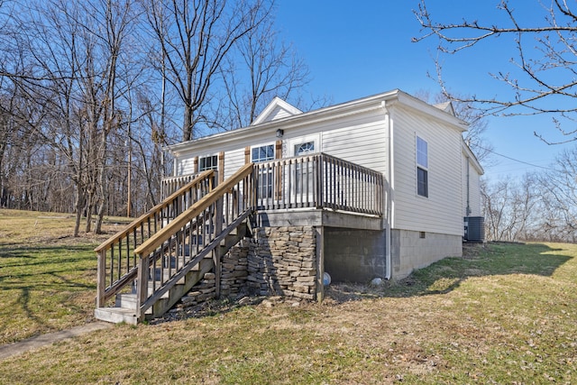 view of front of property with stairs, a front lawn, and a deck