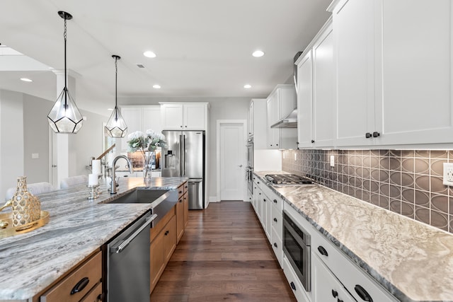 kitchen featuring appliances with stainless steel finishes, brown cabinetry, light stone countertops, and white cabinets