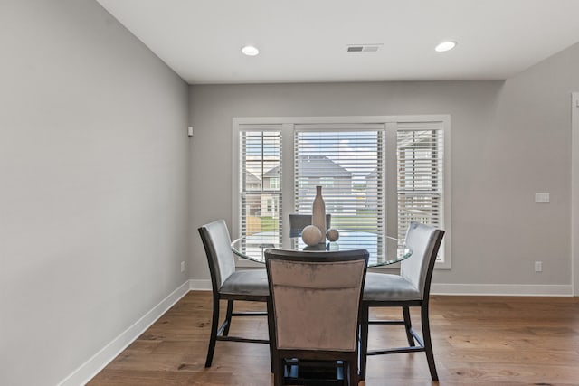 dining room with recessed lighting, wood finished floors, visible vents, and baseboards