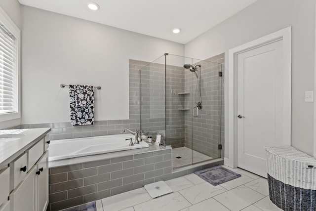 bathroom featuring marble finish floor, a shower stall, a bath, and vanity