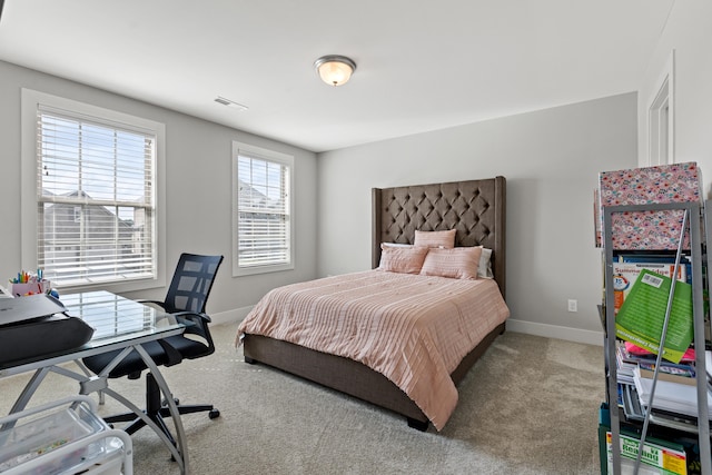 carpeted bedroom with visible vents and baseboards