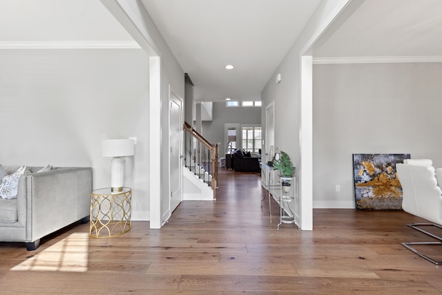 entrance foyer with recessed lighting, ornamental molding, wood finished floors, baseboards, and stairs