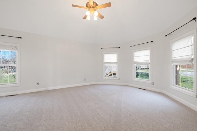 spare room with visible vents, light carpet, and baseboards