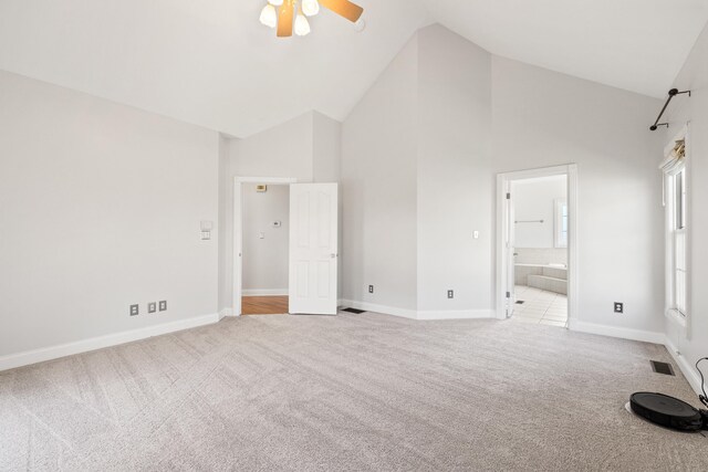 unfurnished bedroom featuring visible vents, carpet floors, high vaulted ceiling, and baseboards