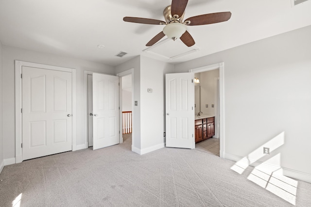 unfurnished bedroom featuring baseboards, visible vents, and light carpet