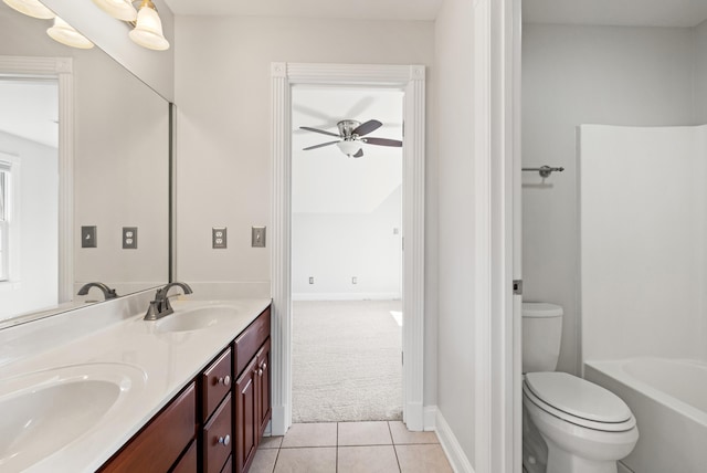 full bathroom featuring tile patterned flooring, double vanity, toilet, and a sink