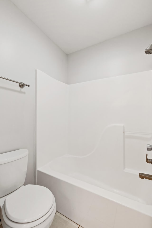 bathroom featuring toilet and  shower combination