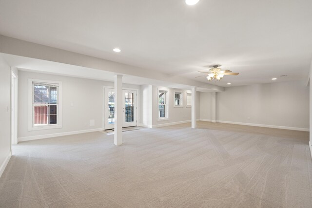 interior space with recessed lighting, baseboards, light carpet, and a wealth of natural light