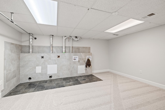 interior space featuring electric dryer hookup, visible vents, baseboards, hookup for a washing machine, and laundry area