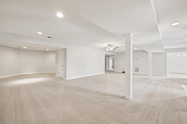 below grade area featuring recessed lighting, visible vents, and light colored carpet