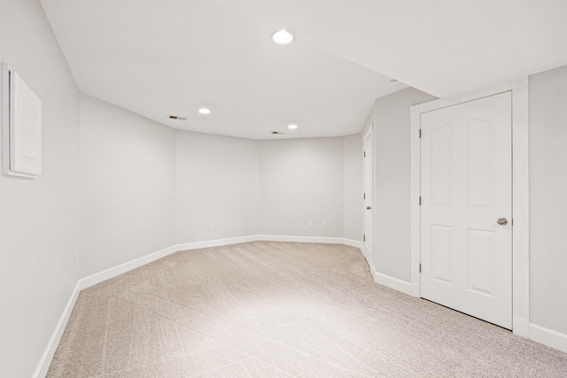 basement featuring recessed lighting, light colored carpet, visible vents, and baseboards