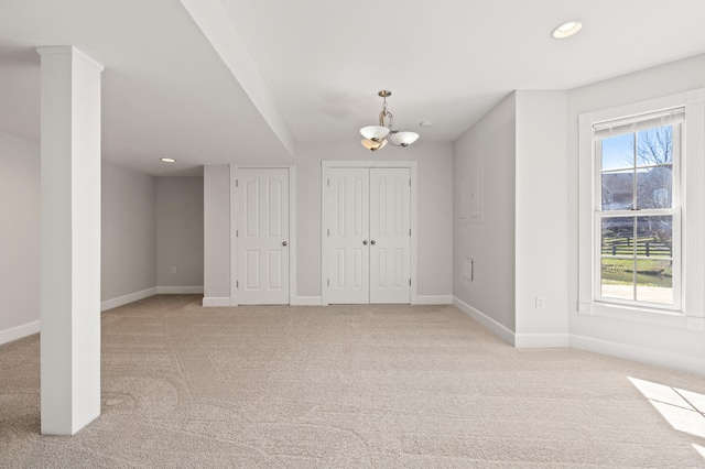 interior space with recessed lighting, baseboards, a chandelier, and light carpet