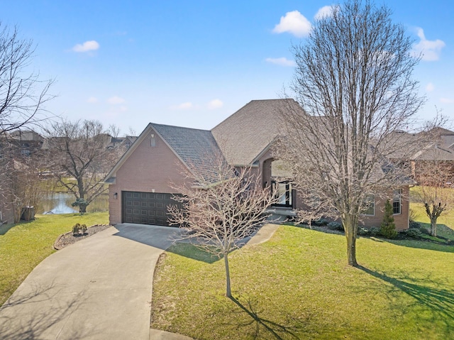 view of front of home featuring brick siding, driveway, a front yard, and an attached garage