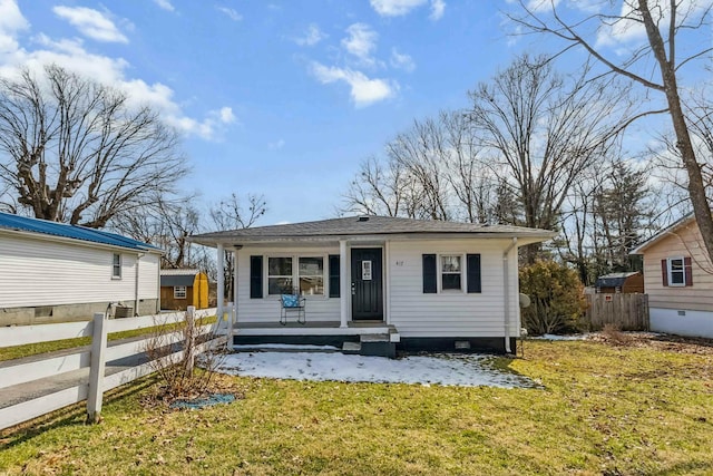 bungalow-style house featuring a porch, fence, and a front lawn