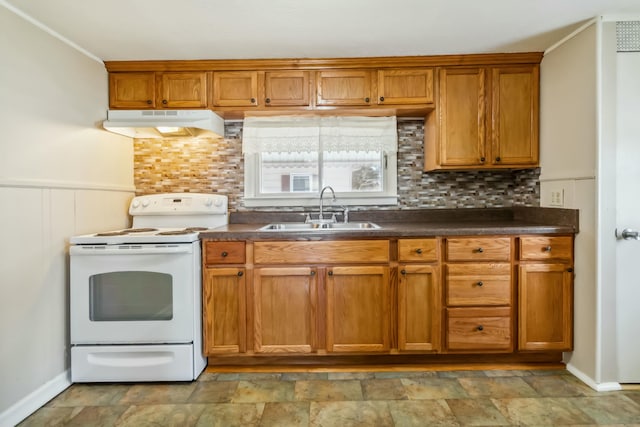 kitchen featuring white range with electric stovetop, dark countertops, stone finish flooring, under cabinet range hood, and a sink