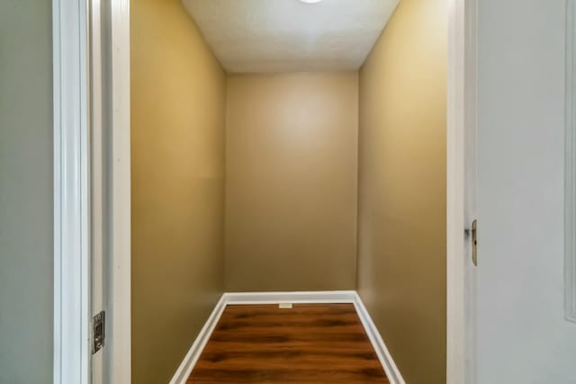 interior space with baseboards and wood finished floors