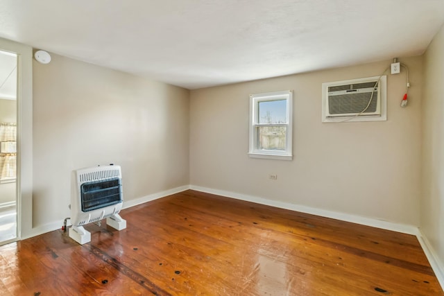 417 Harmon Hts, Stanford, KY 40484 - unfurnished room featuring an AC wall unit, baseboards, wood-type flooring, and heating unit