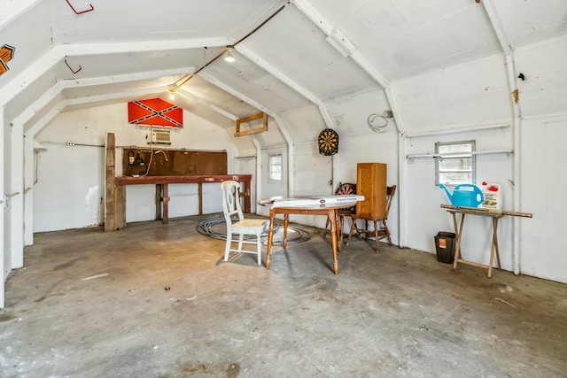 additional living space with lofted ceiling and unfinished concrete floors