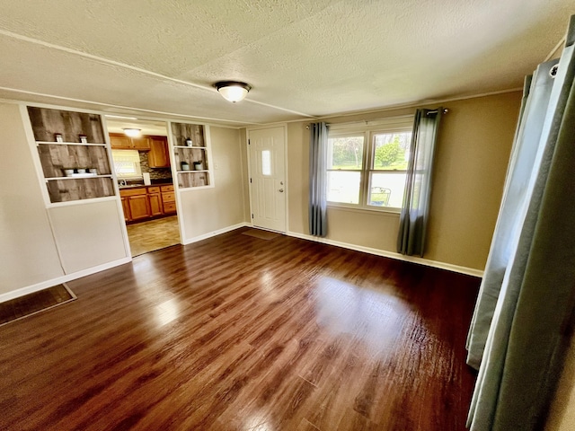 417 Harmon Hts, Stanford, KY 40484 - unfurnished living room with dark wood-type flooring, a textured ceiling, and baseboards