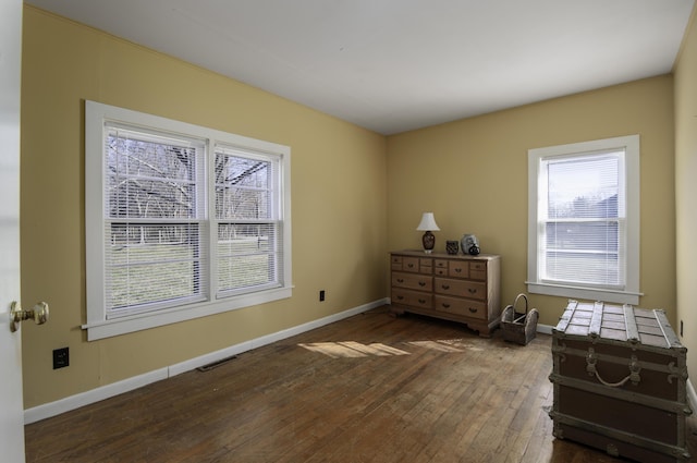 bedroom with wood-type flooring, visible vents, and baseboards