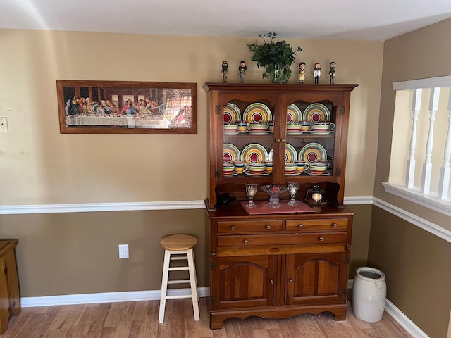 bar with baseboards and wood finished floors