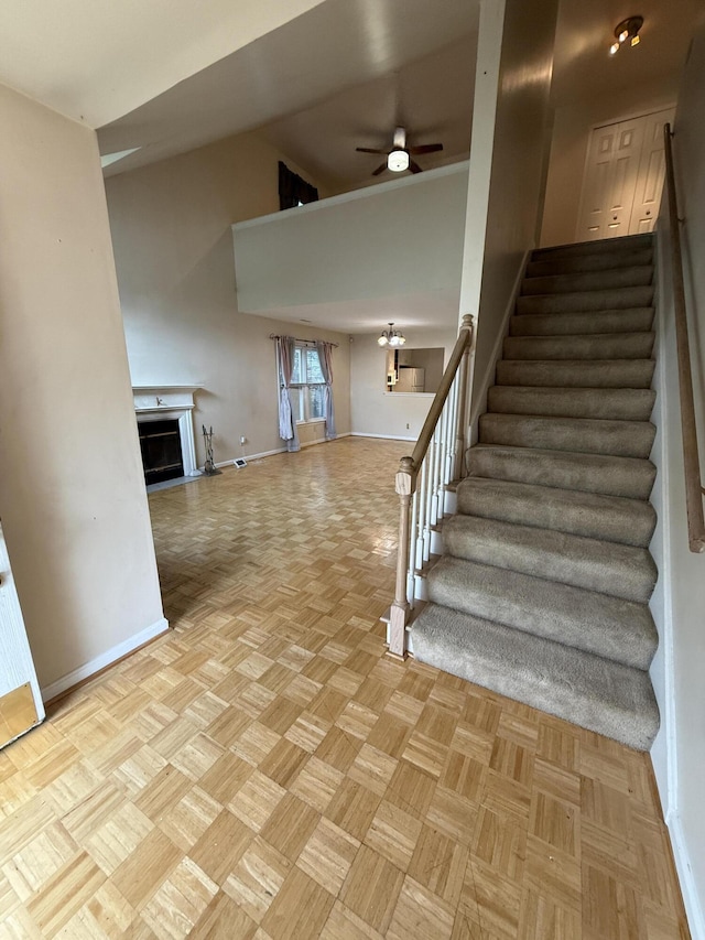 10509 Bay Pointe Ct, Louisville, KY 40241 - staircase featuring ceiling fan, a fireplace, and vaulted ceiling
