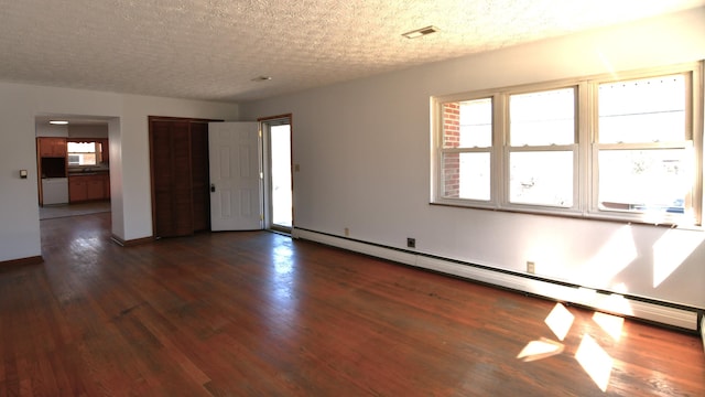 unfurnished room with dark wood-style floors, a textured ceiling, a baseboard radiator, and a healthy amount of sunlight