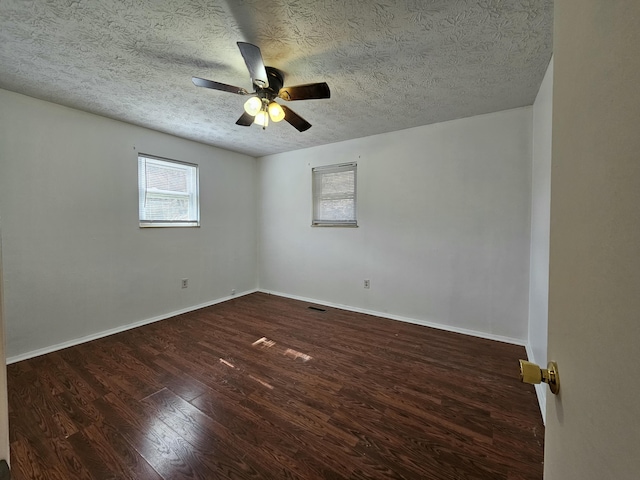 unfurnished room featuring visible vents, baseboards, a ceiling fan, wood finished floors, and a textured ceiling