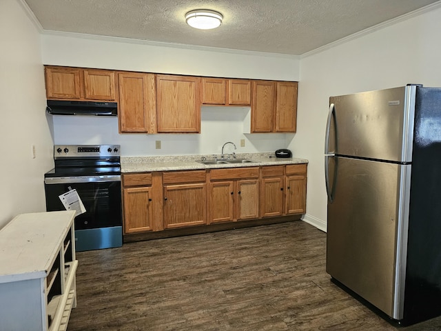 kitchen with under cabinet range hood, a sink, appliances with stainless steel finishes, dark wood-style floors, and brown cabinetry