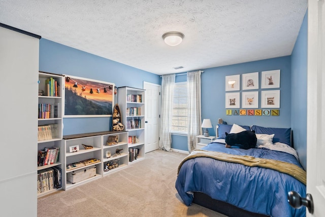 carpeted bedroom with visible vents and a textured ceiling