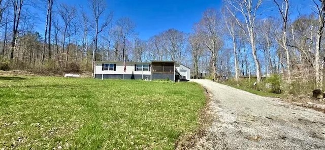 view of front of house with driveway and a front yard