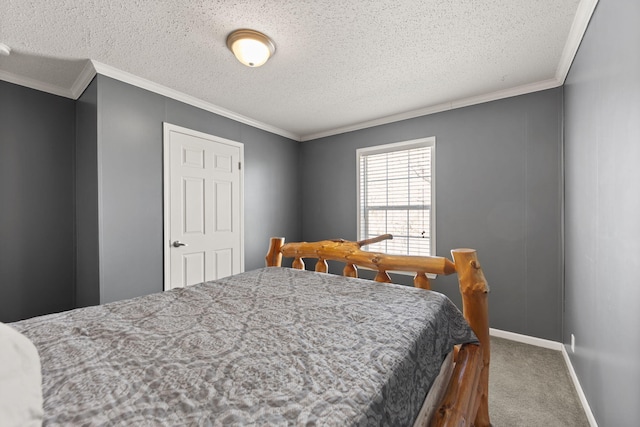 bedroom with a textured ceiling, carpet floors, and crown molding