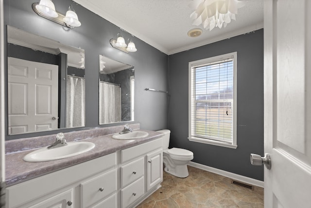 bathroom featuring crown molding, visible vents, toilet, a sink, and a textured ceiling