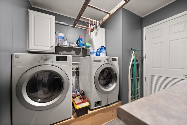 washroom with washing machine and dryer and cabinet space