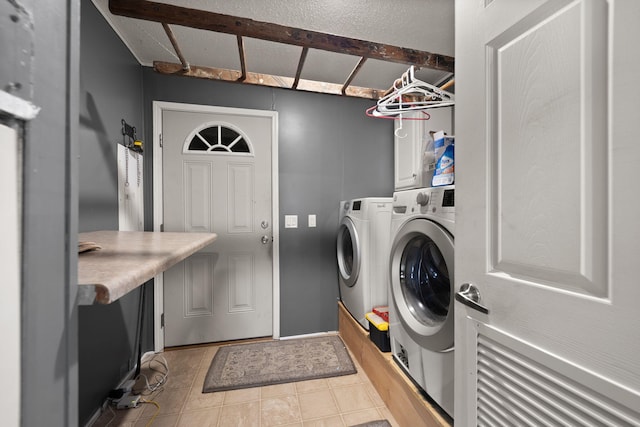 washroom featuring light tile patterned floors, laundry area, and washer and clothes dryer