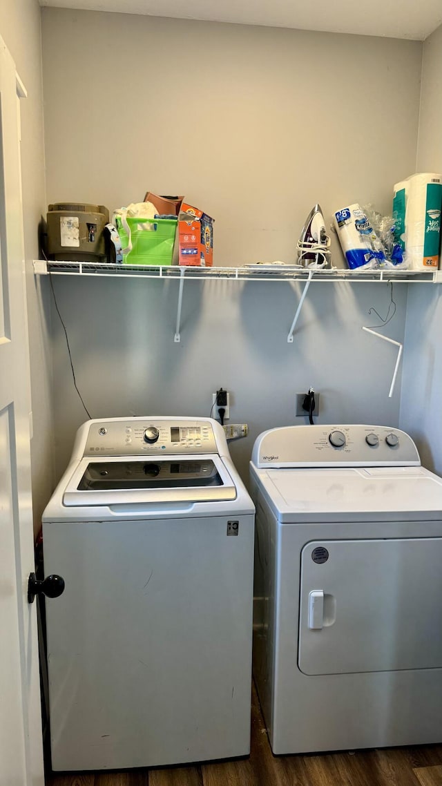 washroom featuring dark wood-style floors, laundry area, and washer and dryer