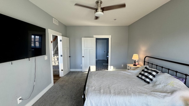 bedroom with ceiling fan, dark carpet, visible vents, and baseboards