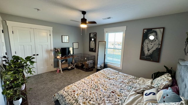 carpeted bedroom with ceiling fan, visible vents, and a closet