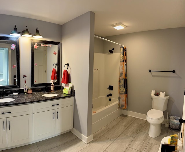 full bathroom featuring a sink, double vanity, toilet, and shower / tub combo with curtain