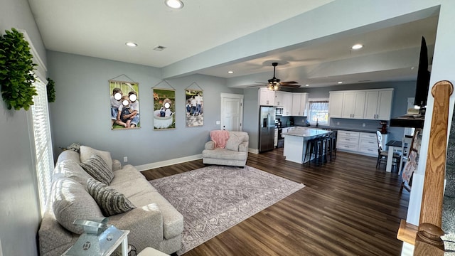 living room with visible vents, baseboards, a ceiling fan, dark wood-style flooring, and recessed lighting