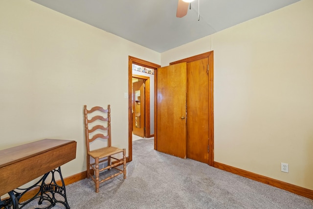 home office featuring light carpet, ceiling fan, and baseboards