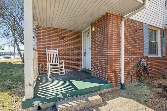 view of exterior entry with brick siding