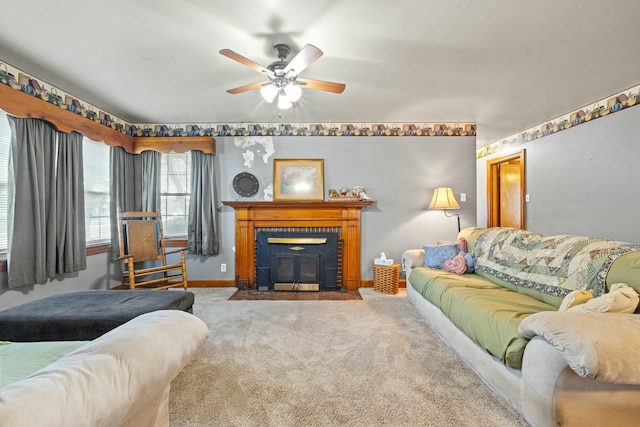 living area with ceiling fan, baseboards, and carpet flooring