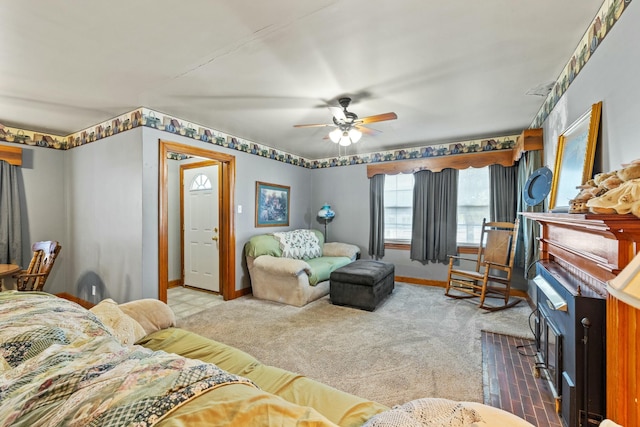 carpeted living area featuring ceiling fan and baseboards