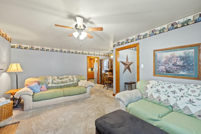 carpeted living room with ceiling fan