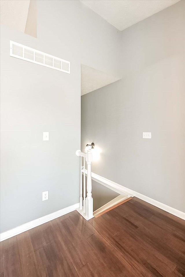 interior space with wood finished floors, visible vents, and baseboards