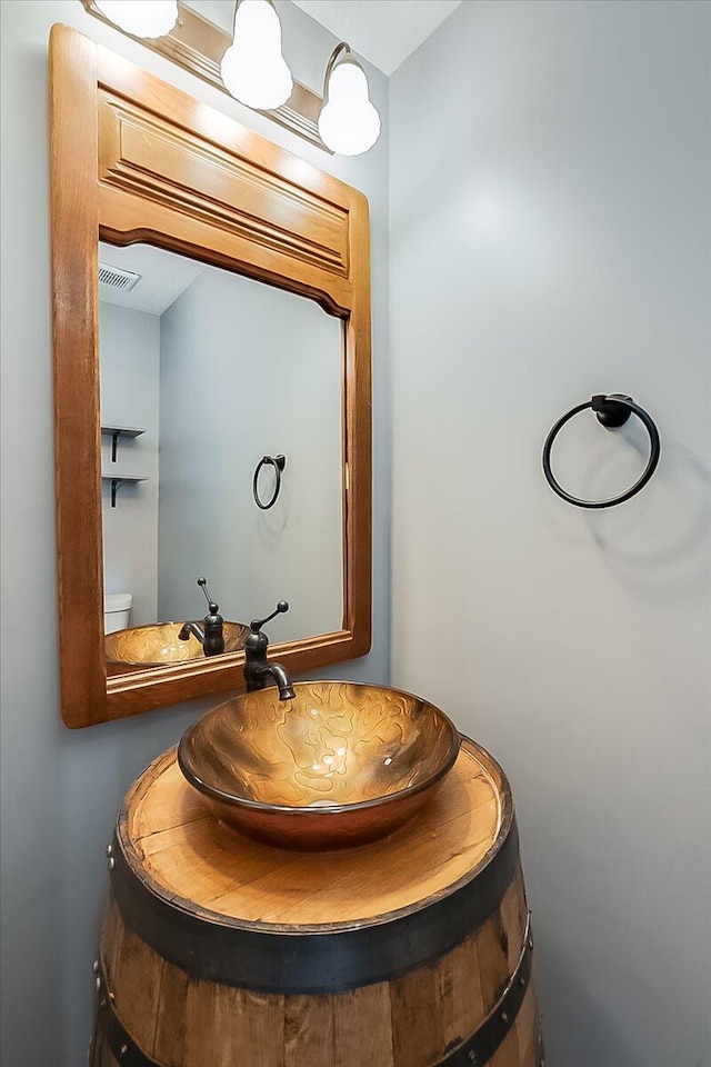 bathroom with visible vents and toilet