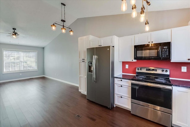 kitchen featuring appliances with stainless steel finishes, dark countertops, pendant lighting, and white cabinets